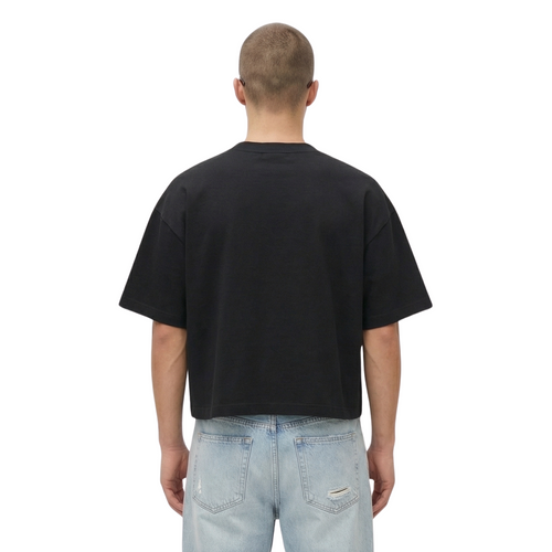 Person wearing a black t-shirt and light blue jeans on a white background